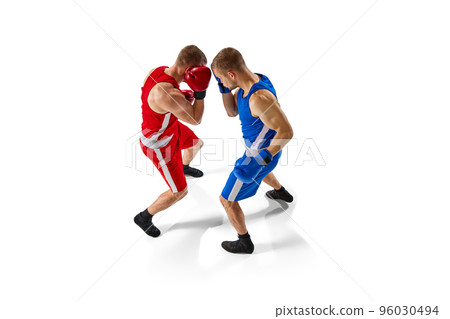 Aerial view of two muscular professional boxers in blue and red sportswear training isolated on white background. Professional sport 96030494