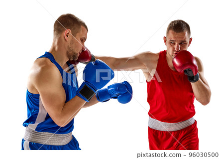 Battle of two boxers. Two muscular professional boxers in blue and red sportswear training isolated on white background. Concept of sport 96030500