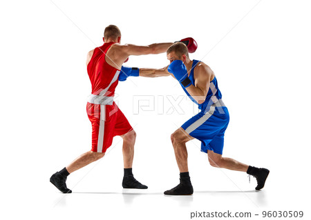 Fight. Dynamic portrait of two professional boxer in sports uniform boxing isolated on white background. Concept of sport, competition, training, energy. Fight. Dynamic portrait of two professional boxer in sports uniform boxing isolated on white background. Concept of sport, competition, training, energy. 96030509
