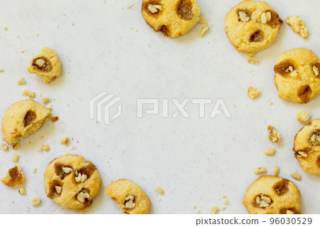 Baked Christmas cookies. Homemade Chip Cookies with Caramel and Salted Peanuts on a light stone table. Top view flat lay background. Copy space. Baked Christmas cookies. Homemade Chip Cookies with Caramel and Salted Peanuts on a light stone table. Top view flat lay background. Copy space. 96030529