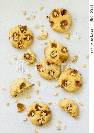 Baked Christmas cookies. Homemade Chip Cookies with Caramel and Salted Peanuts on a light stone table. Baked Christmas cookies. Homemade Chip Cookies with Caramel and Salted Peanuts on a light stone table. 96030531