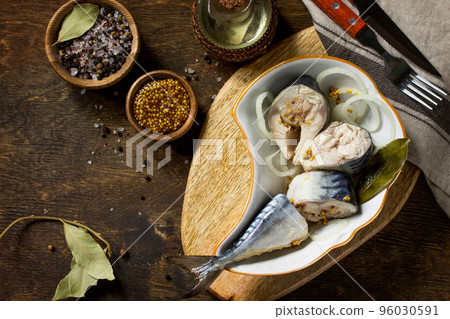 Marinated Fish. Marinated Mackerel with Spices on a wooden table. Top view flat lay background. Copy space. Marinated Fish. Marinated Mackerel with Spices on a wooden table. Top view flat lay background. Copy space. 96030591