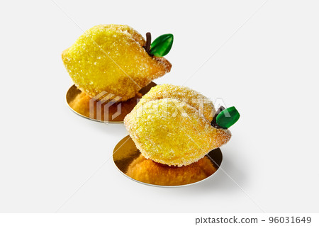 Two lemon shaped shortcrust pastry cakes covered in sugar with citrus curd filling Two lemon shaped shortcrust pastry cakes covered in sugar with citrus curd filling 96031649