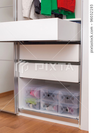 Storage of shoes in the wardrobe. Home organization. 96032193