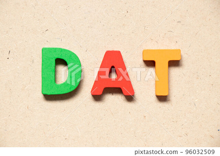 Color alphabet letter in word DAT (Abbreviation of Delivery at Terminal) on wood background 96032509