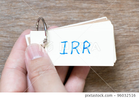 Hand hold flash card with handwriting in word IRR (Abbreviation of internal rate of return) on wood background Hand hold flash card with handwriting in word IRR (Abbreviation of internal rate of return) on wood background 96032516
