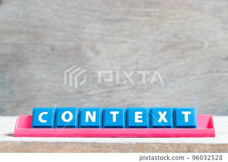 Tile alphabet letter with word context in red color rack on wood background Tile alphabet letter with word context in red color rack on wood background 96032528