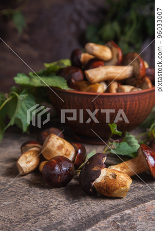 Pile of Imleria Badia or Boletus badius mushrooms commonly known as the bay bolete on vintage wooden background.. Pile of Imleria Badia or Boletus badius mushrooms commonly known as the bay bolete on vintage wooden background.. 96033007