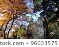 Autumn leaves and a stone monument under the blue sky 96033575