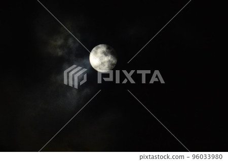 The moon hiding in the clouds 96033980