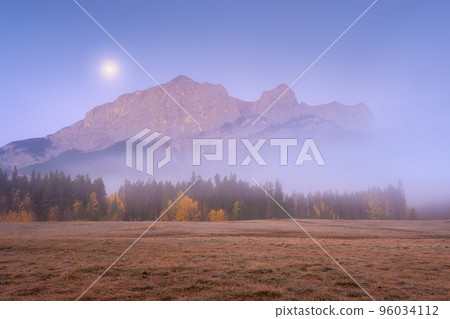 Mountain landscape at dawn. Fog in a valley. Field and forest in a mountain valley at dawn. Canada 96034112