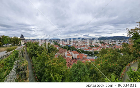Cityscape of old town of Graz and the Clock Tower (Grazer Uhrturm), famous tourist attraction in Graz, Steiermark, Austria, in cloudy summer day. Cityscape of old town of Graz and the Clock Tower (Grazer Uhrturm), famous tourist attraction in Graz, Steiermark, Austria, in cloudy summer day. 96034831