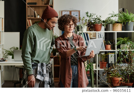 Young confident businesswoman making presentation to coworker 96035611