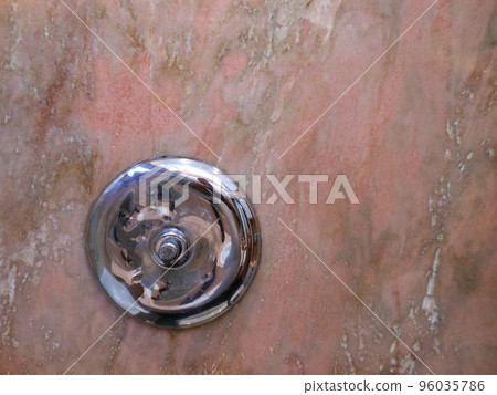 Silver round object on marble background 96035786