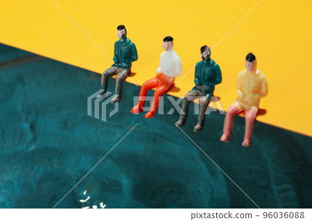 Concept of summer, toy people sit near water Concept of summer, toy people sit near water 96036088