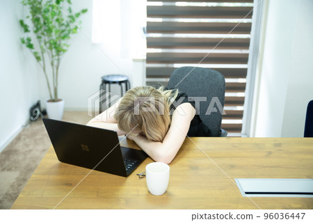Tired woman working in the office Tired woman working in the office 96036447