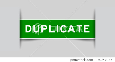 Inserted green color label sticker with word duplicate on gray background 96037077