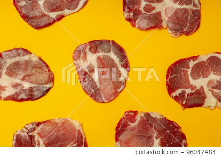 Flat lay with with jamon on orange background Flat lay with with jamon on orange background 96037483