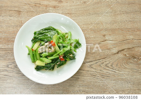 fried Chinese kale with chop salty fish in oyster sauce on plate fried Chinese kale with chop salty fish in oyster sauce on plate 96038108