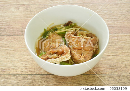deep fried bass fish slice dressing soy sauce and spring onion on bowl deep fried bass fish slice dressing soy sauce and spring onion on bowl 96038109