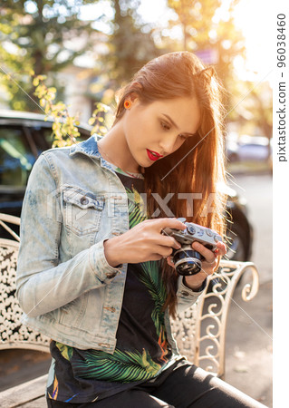 Portrait of a pretty young tourist taking photographs with vintage retro camera Portrait of a pretty young tourist taking photographs with vintage retro camera 96038460