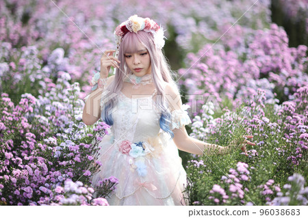 Beautiful young woman with white lolita dress with flowers garden Japanese fashion 96038683