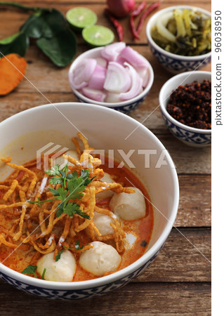 Local northern Thai food Egg noodle curry with meatballs on wood background 96038950