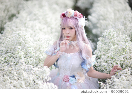 Portrait of Asian young woman with lolita fashion dress in white flower garden background 96039091