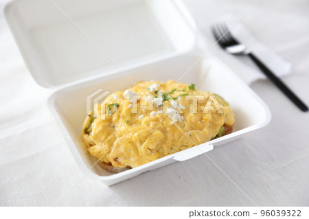 Avocado and scrambled eggs toast with delivery package in white background 96039322