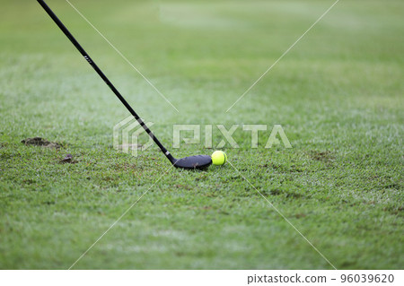 Golf ball on green grass ready to be struck on grass background Golf ball on green grass ready to be struck on grass background 96039620