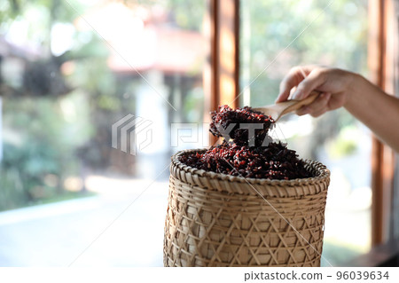 Boiled riceberry rice on wood basket with spoon in close up Boiled riceberry rice on wood basket with spoon in close up 96039634