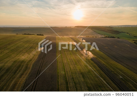 Aerial view of combine harvesters working during harvesting season on large ripe wheat field. Agriculture concept 96040051