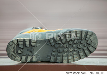 A leather trekking hiking winter boot on blurred background 96040106