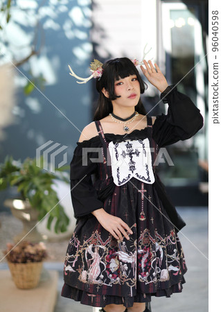 Portrait of asian girl in lolita fashion dress in vintage garden background Portrait of asian girl in lolita fashion dress in vintage garden background 96040598