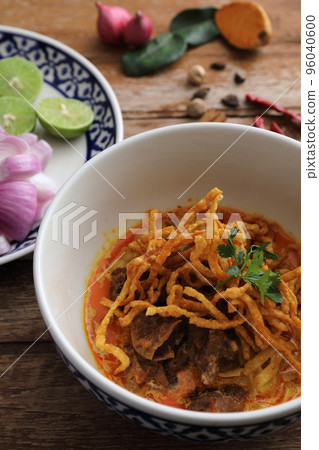 Local northern Thai food Egg noodle curry with beef on wood background Local northern Thai food Egg noodle curry with beef on wood background 96040600
