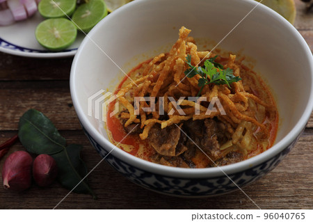 Local northern Thai food Egg noodle curry with beef on wood background 96040765
