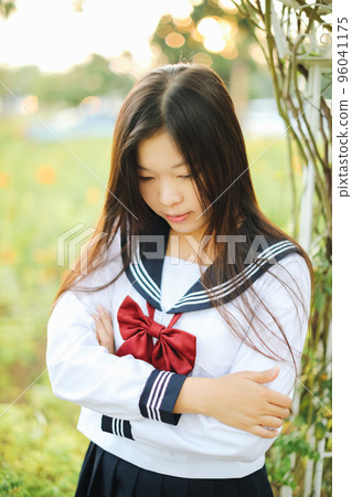 school girl costume at park outdoor with flowers garden background school girl costume at park outdoor with flowers garden background 96041175