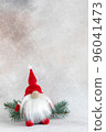 Christmas elf in red hat with fir branch holiday card on light winter background 96041473