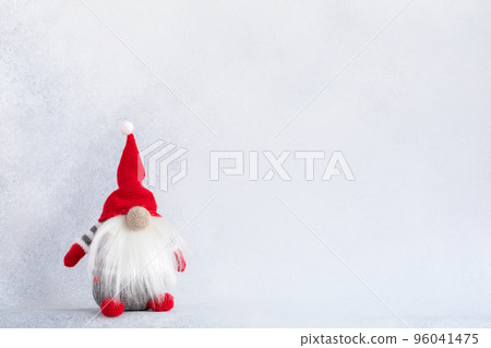 Christmas gnome in red hat holiday banner on light winter background Christmas gnome in red hat holiday banner on light winter background 96041475