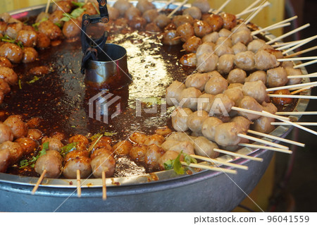 closeup hot beef Meatballs with dipping sauce stacked on steel tray closeup hot beef Meatballs with dipping sauce stacked on steel tray 96041559