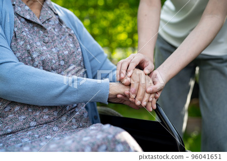 Caregiver holding hands Asian elderly woman patient, help and car in hospital. 96041651