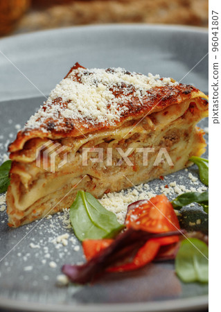Homemade delicious Meat lasagna with basil leaf on the top. Close up. Recipe, menu. Italian cuisine. Side view 96041807