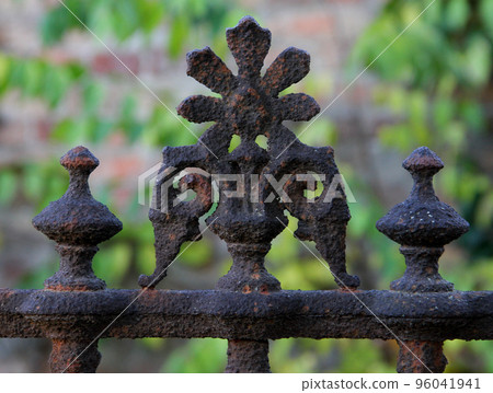 Old brown rusty weathered fence ornament close up. Old brown rusty weathered fence ornament close up. 96041941
