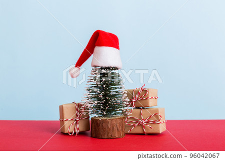 Christmas composition. Gifts, small tree, branches and craft DIY decorations on white background. New year concept. Christmas home decoration Flat lay, top view, copy space Christmas composition. Gifts, small tree, branches and craft DIY decorations on white background. New year concept. Christmas home decoration Flat lay, top view, copy space 96042067