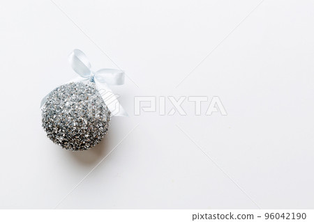 Christmas ball on colored background. decoration bauble with ribbon bow with copy space 96042190