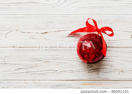 Christmas ball on colored background. decoration bauble with ribbon bow with copy space Christmas ball on colored background. decoration bauble with ribbon bow with copy space 96042191