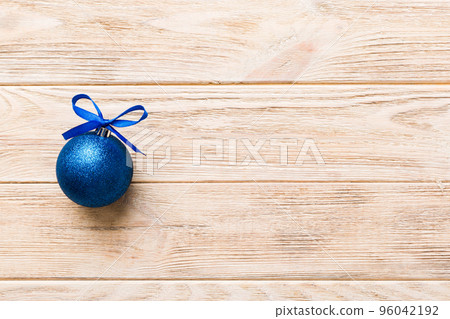 Christmas ball on colored background. decoration bauble with ribbon bow with copy space Christmas ball on colored background. decoration bauble with ribbon bow with copy space 96042192