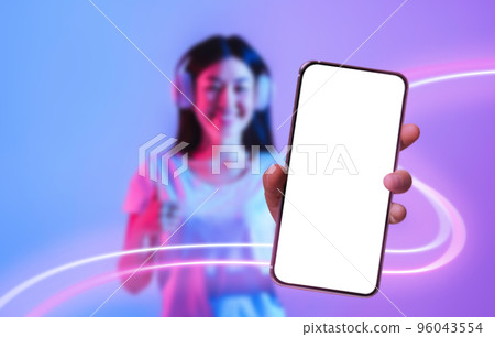 Cheerful korean lady enjoying newest musical mobile app, mockup Cheerful korean lady enjoying newest musical mobile app, mockup 96043554