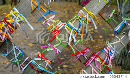 Many colorful ribbons on the fence with selective focus and blurred background 96043744