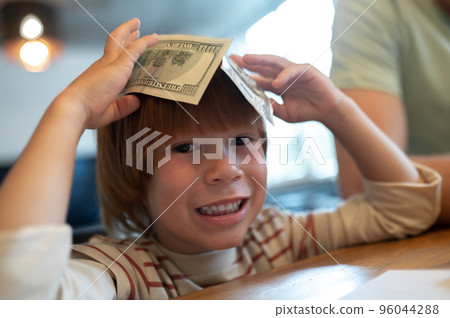 Dad explaining his son the importance of financial literacy Dad explaining his son the importance of financial literacy 96044288